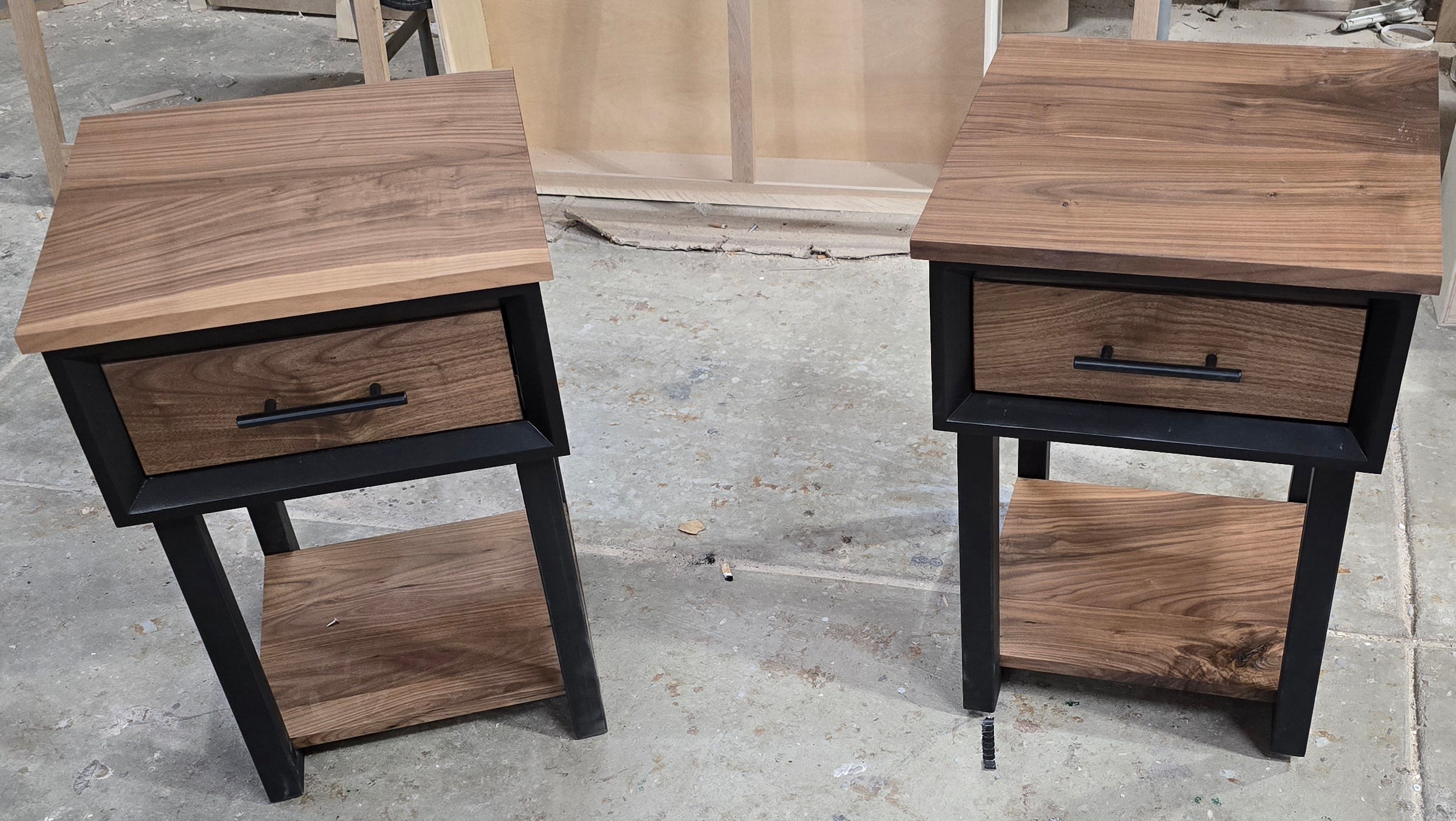 Modern Black and walnut nightstand with drawer and shelf on steel legs.