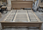 Centered front view of white oak platform bed and panel headboard in the workshop