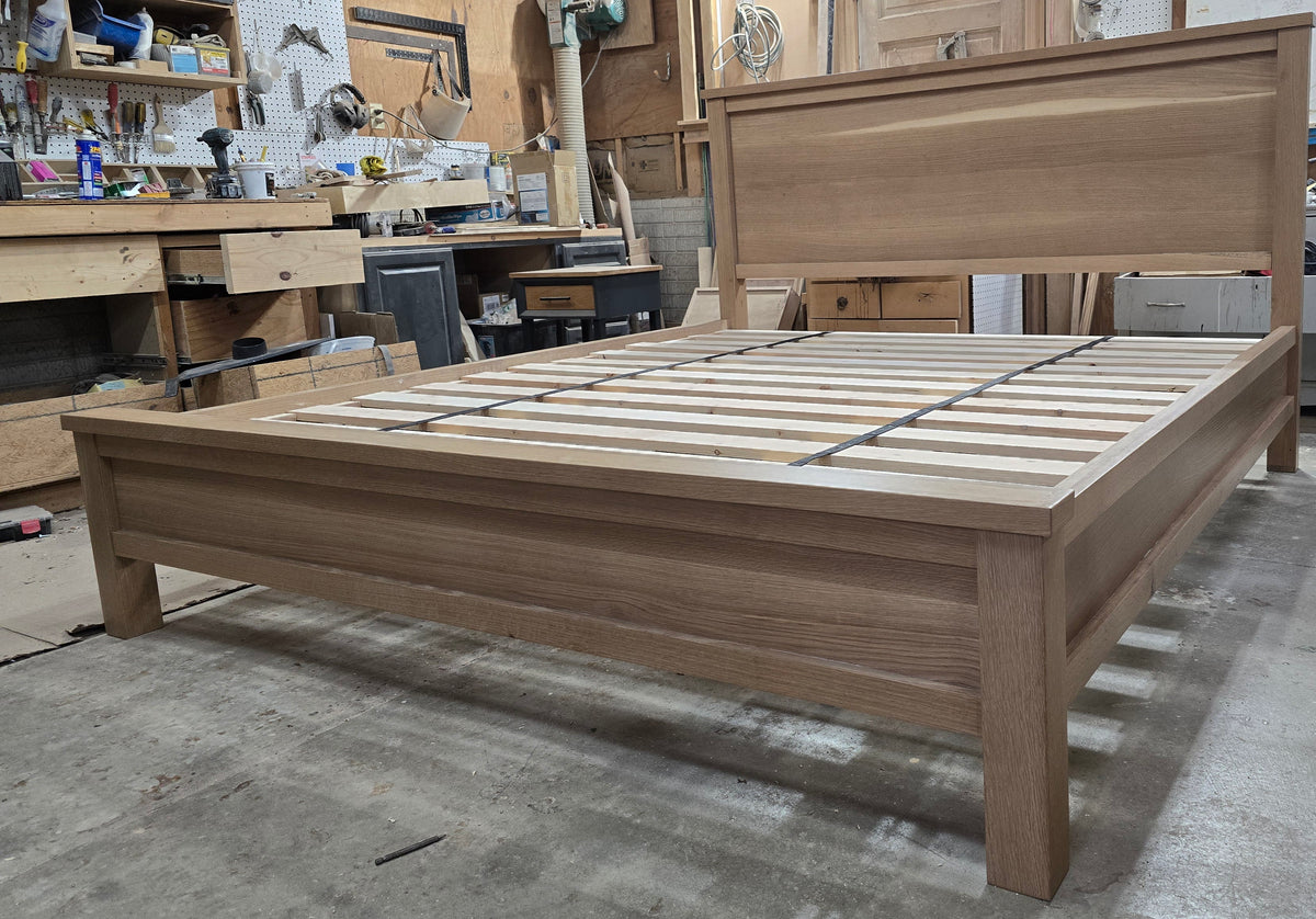 Close angled workshop view of white oak footboard and bed slats