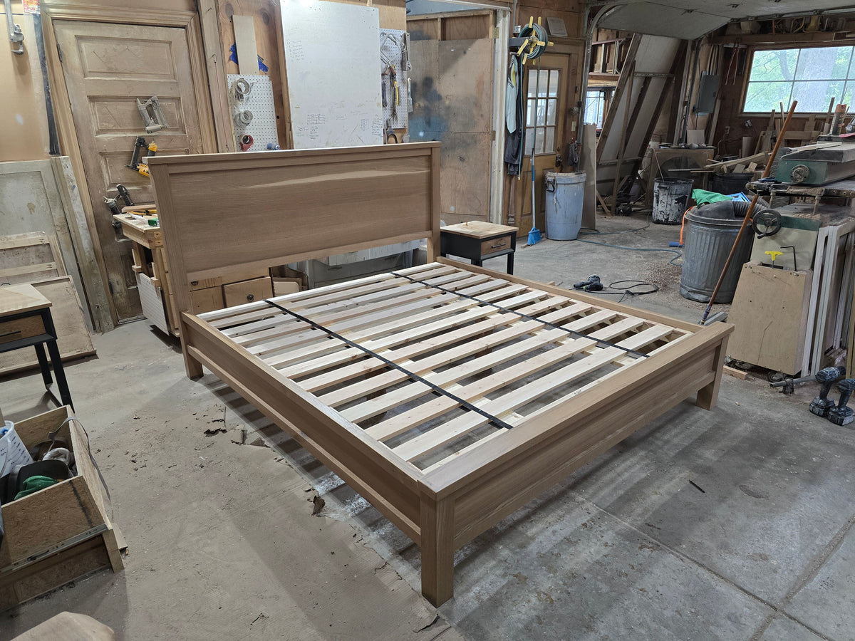 Elevated angled view of white oak platform bed in the workshop