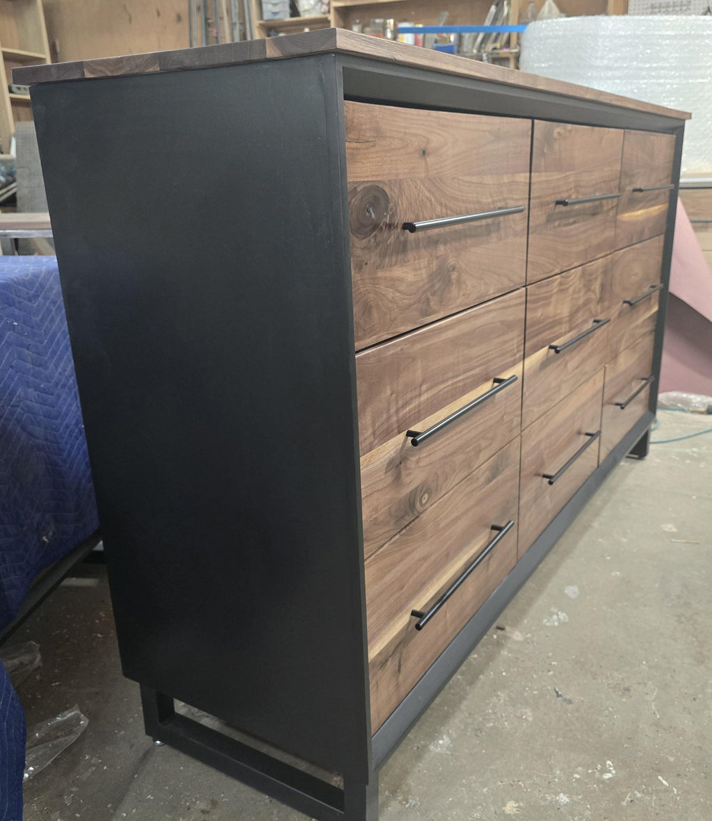 6foot 9 drawer walnut faced modern dresser in black with solid walnut top on steel legs.