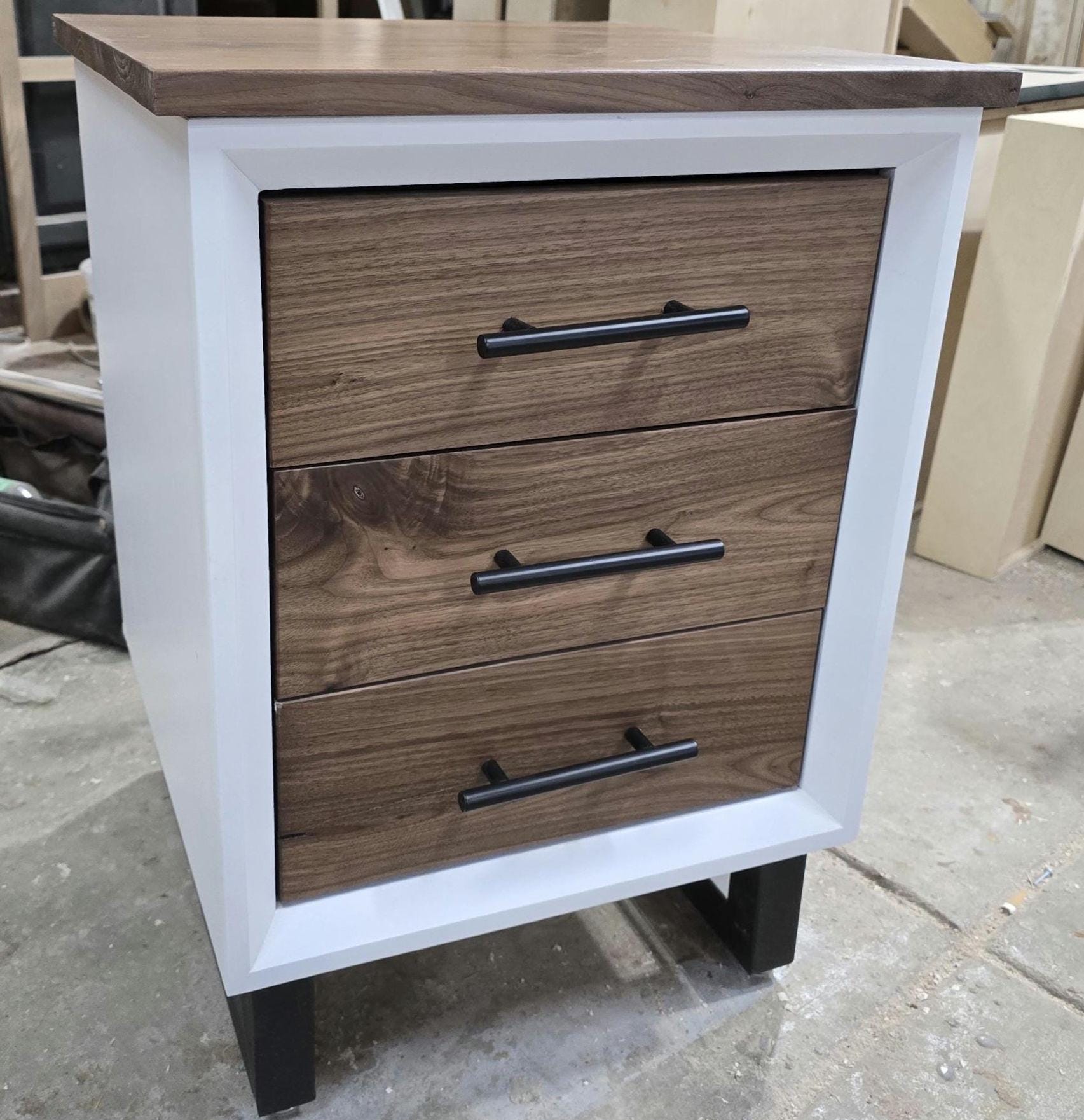 Handcrafted to order. 3 drawer nightstand in a white finish with real walnut fronts and top.