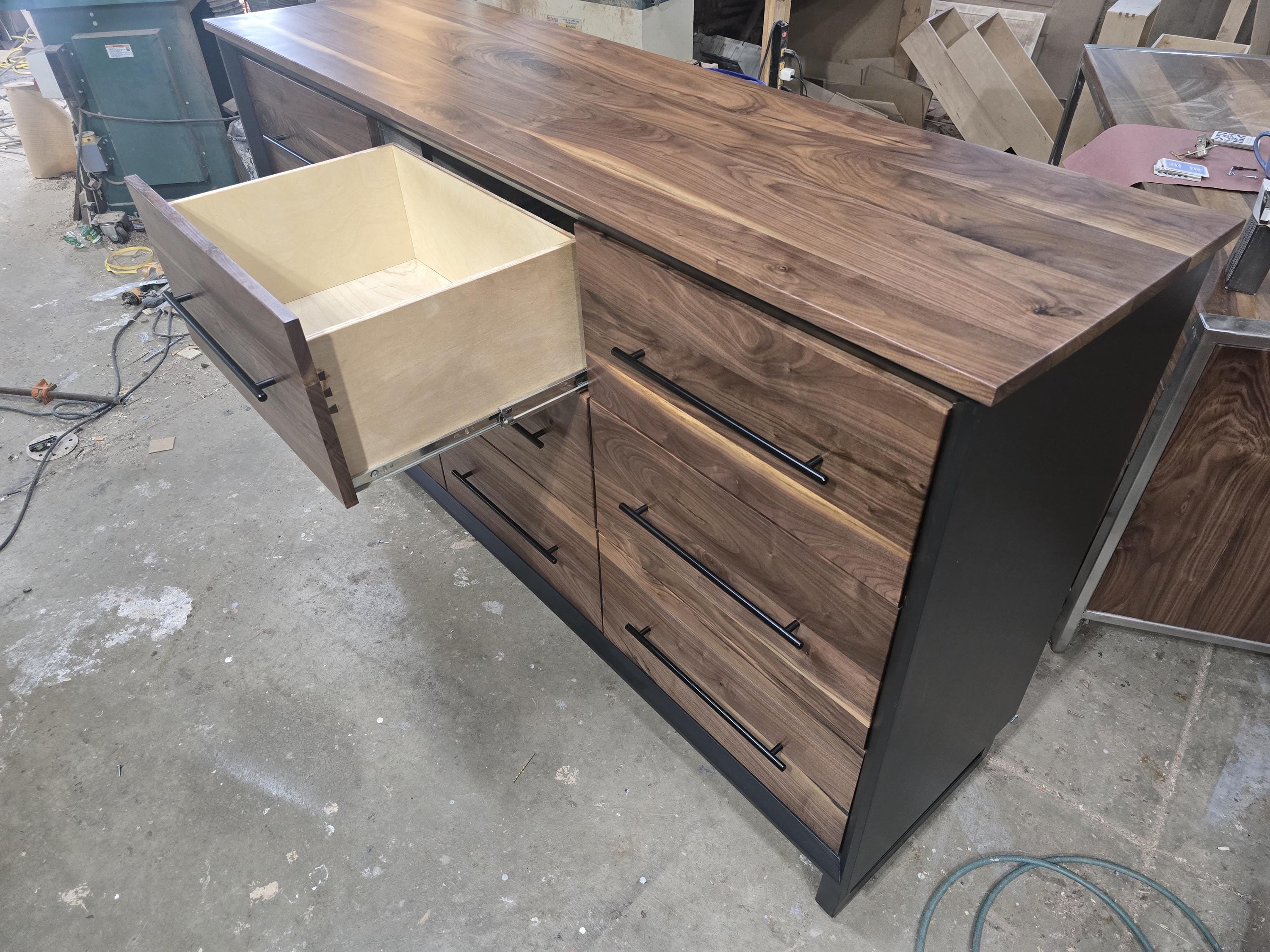 6foot 9 drawer walnut faced modern dresser in black with solid walnut top on steel legs.