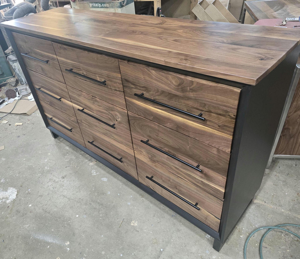 6foot 9 drawer walnut faced modern dresser in black with solid walnut top on steel legs.