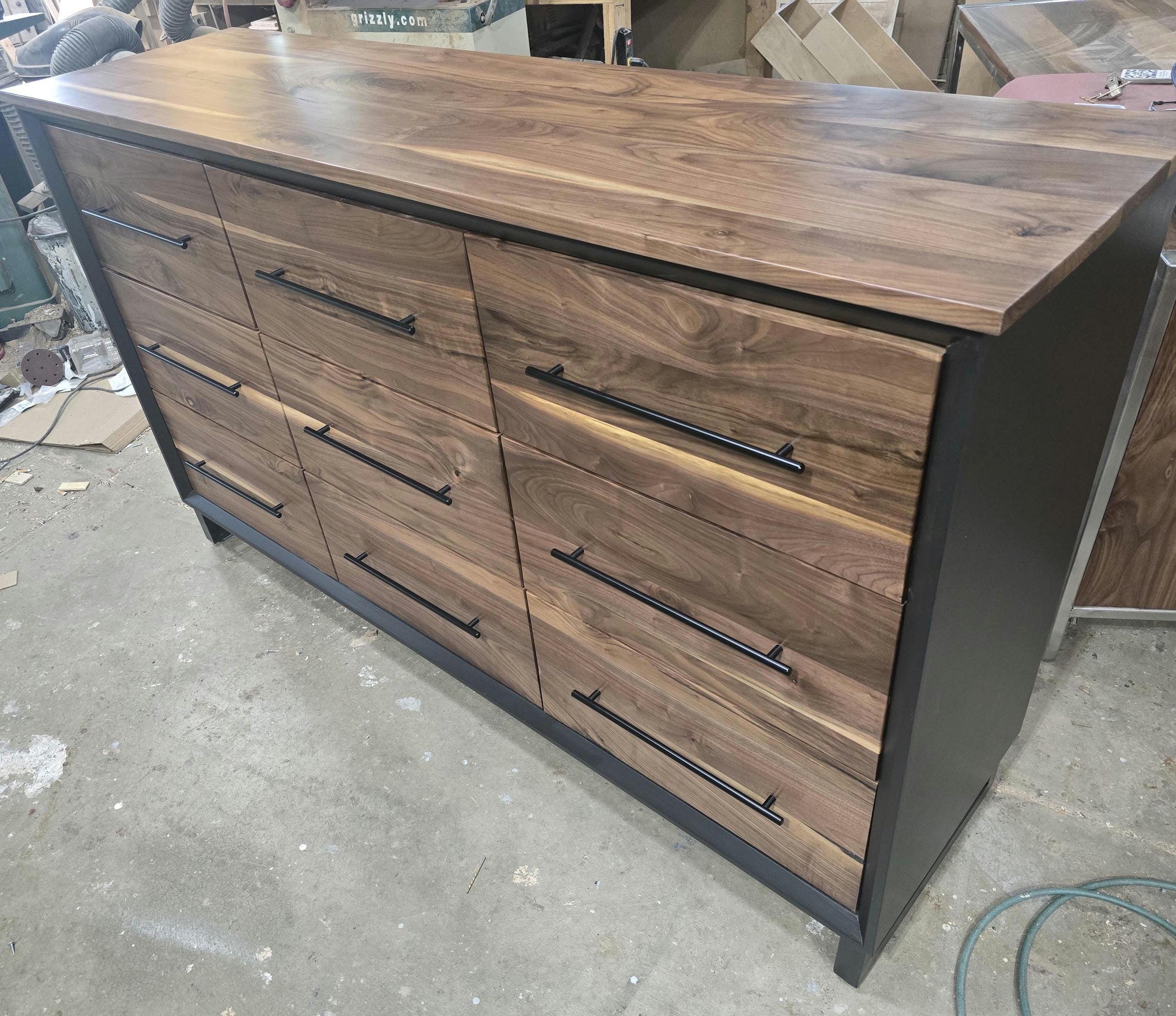 6foot 9 drawer walnut faced modern dresser in black with solid walnut top on steel legs.